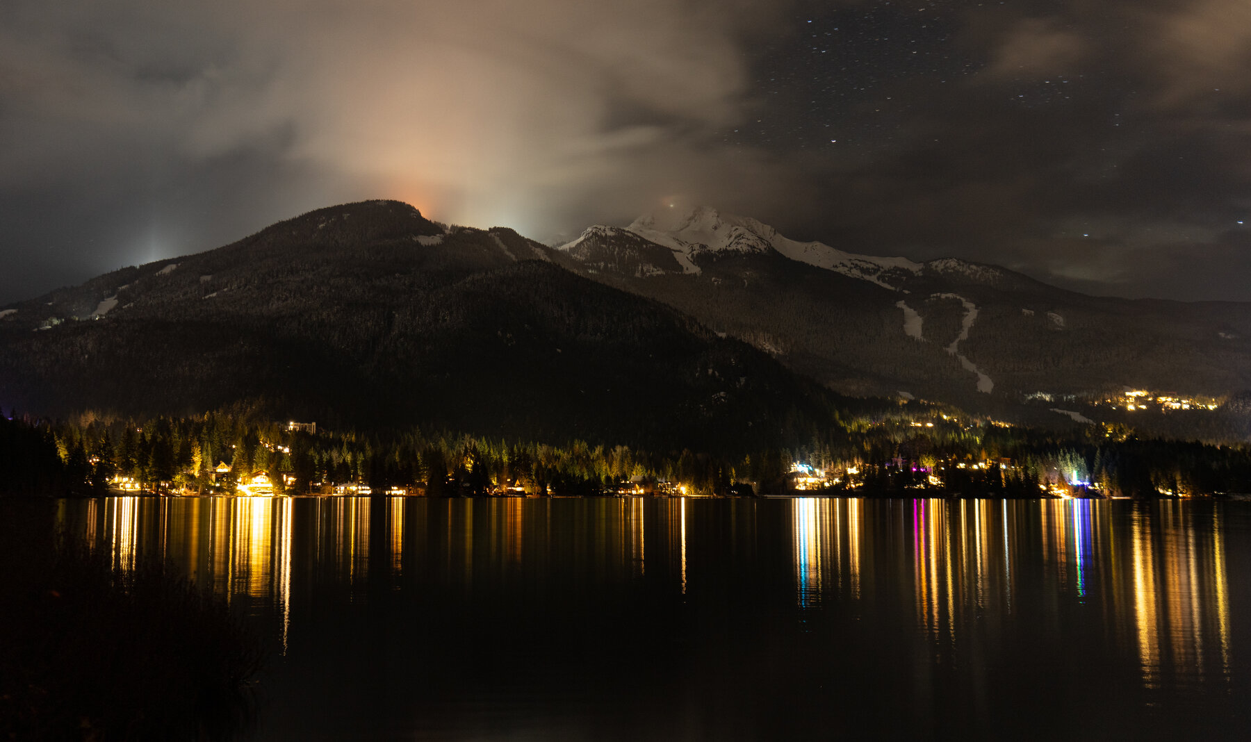 Whistler at night, lakeside lights reflecting on the water